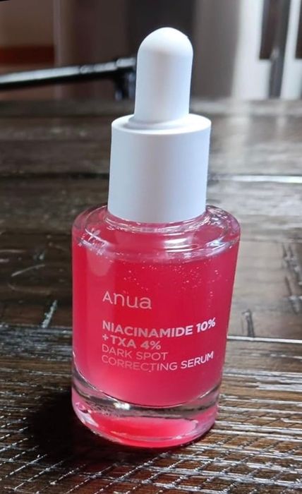 A reviewer's bottle of Anua serum featuring Niacinamide 10% and Bakuchiol 4%