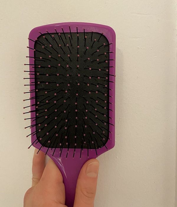 The same hairbrush now spotless and free of debris