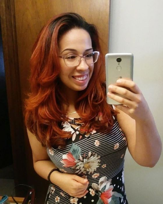 A reviewer showcasing their smooth, blow-dried hair