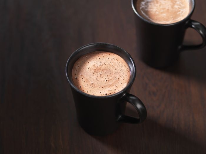 Two steaming mugs of hot chocolate.