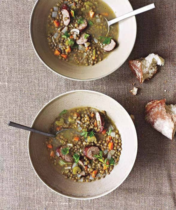 Lentil and Kielbasa Stew in Two Large Soup Bowls With Spoons