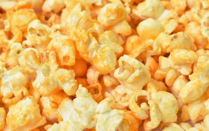 A close-up of cheesy popcorn.
