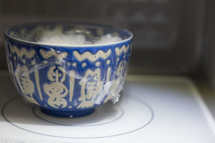 A bowl of rice being heated in a microwave.
