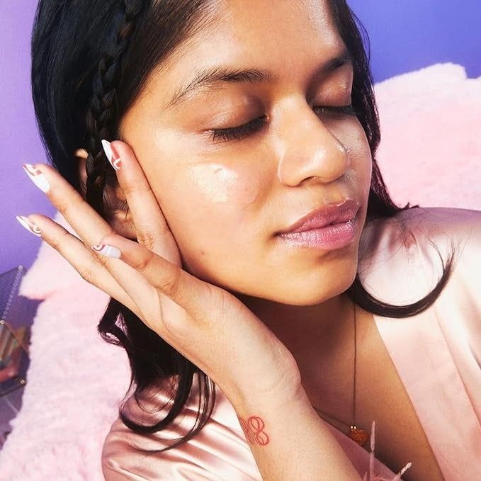 A model gently applying the cream onto their face