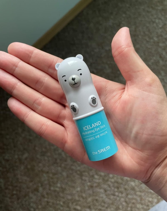 A reviewer holding the adorable polar bear-themed Iceland Hydrating Eye Stick by The Saem