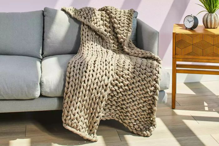 The Yaasa Serenity Knit Weighted Blanket displayed on a cozy couch
