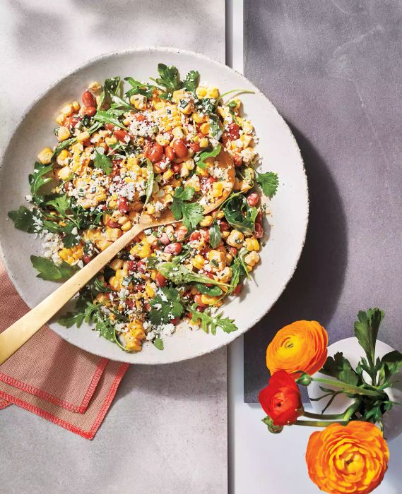 Spicy Street Corn Salad presented in a serving dish with a spoon.