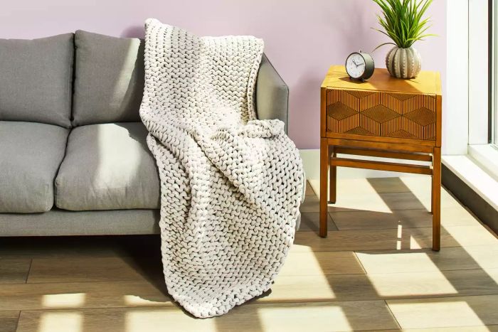 Bearaby Cotton Weighted Blanket elegantly draped on a sofa