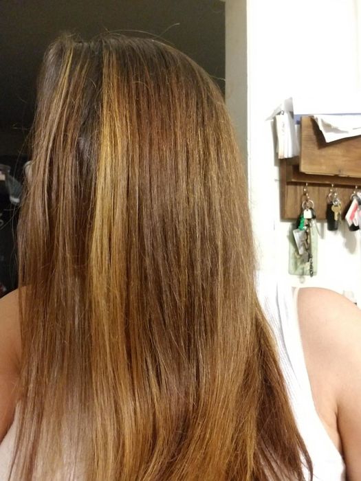 A reviewer's hair before using the tool, showing straight strands