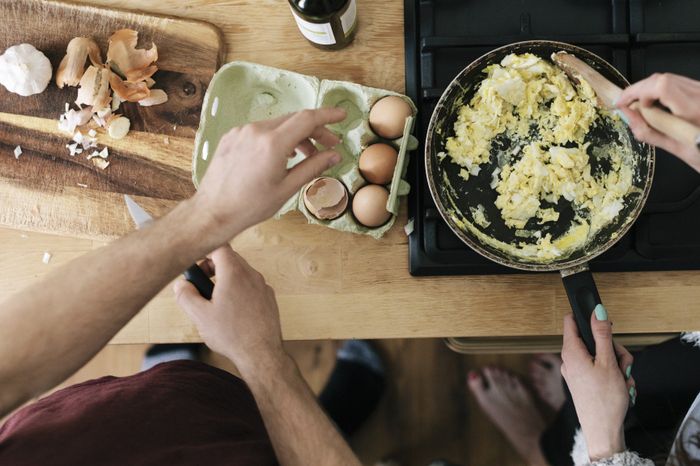A couple preparing scrambled eggs