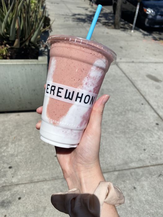 The author holding a smoothie