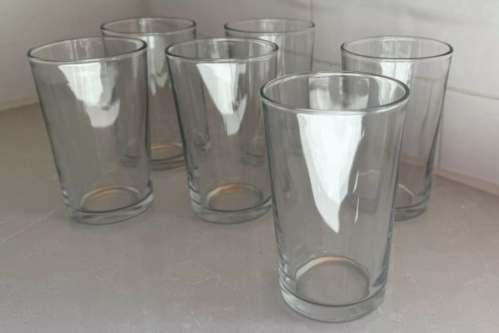 Six Duralex Unie Glass Tumblers arranged on a white countertop