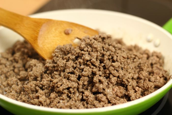 Ground beef cooking in a skillet.