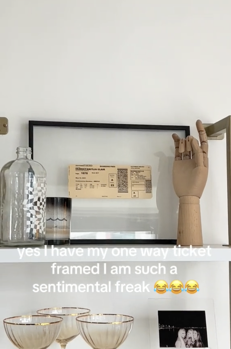 A shelf displaying a framed ticket, a wooden hand sculpture, glasses, and a bottle. Text overlay highlights a heartfelt message about sentimental value