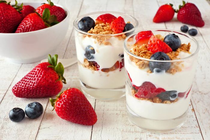A delicious yogurt parfait featuring strawberries, blueberries, and crunchy granola