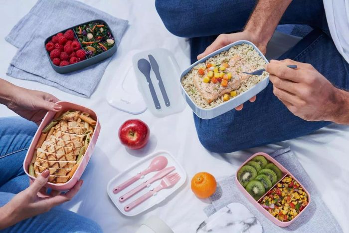 A couple of people holding the Bentgo Classic Lunch Box