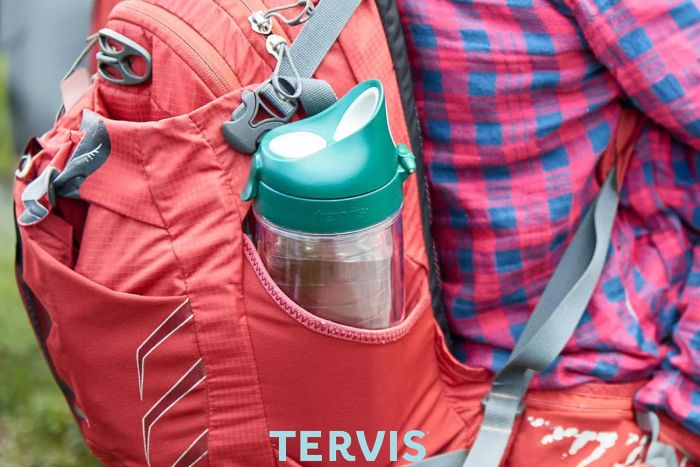 A person carrying the Tervis #1 Teacher Apple Water Bottle in a bag