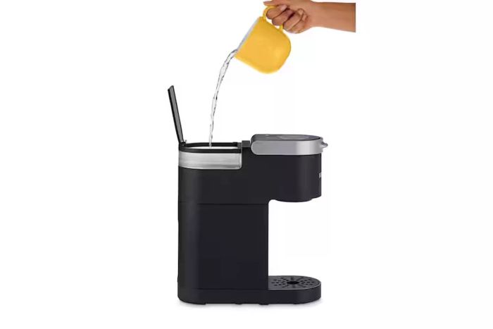 A person filling the Keurig K-Mini Coffee Maker with water