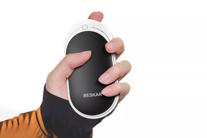 A person holding the Beskar Rechargeable Hand Warmer