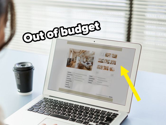 A person sits at a desk, browsing a website on a laptop with a coffee cup nearby. The website shows interior photos and text, likely property listings or design inspiration