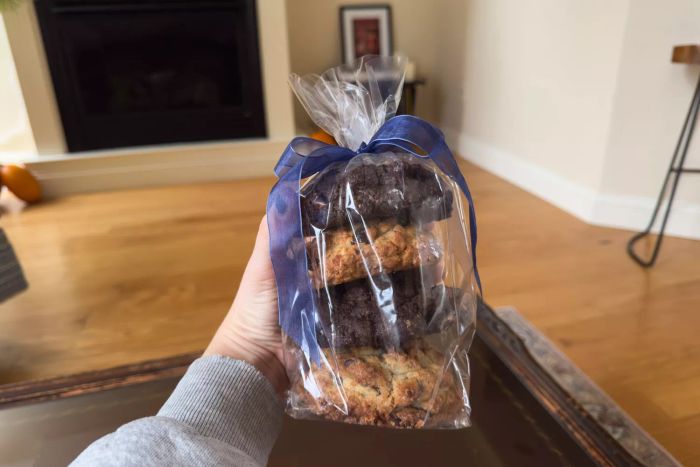 A person holding the Levain Bakery Signature Cookie Assortment Gift Box