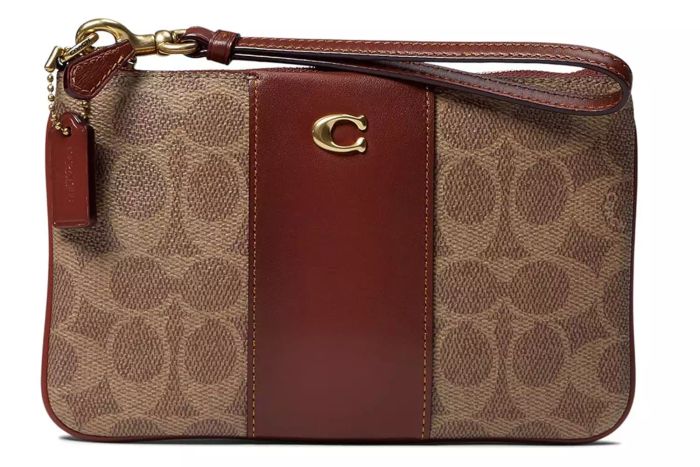 The Coach Women's Coated Canvas Signature Small Wristlet from Amazon is a stylish, practical accessory, designed to combine elegance and functionality in a compact form.