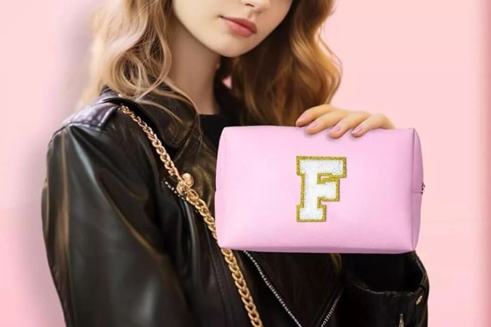 A person holding the TOPEAST Monogrammed Toiletry Bag