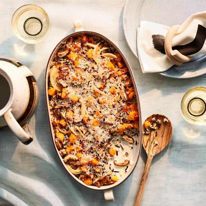 This dish combines roasted butternut squash with caramelized onions and mushrooms, creating a hearty and flavorful wild rice bake.
