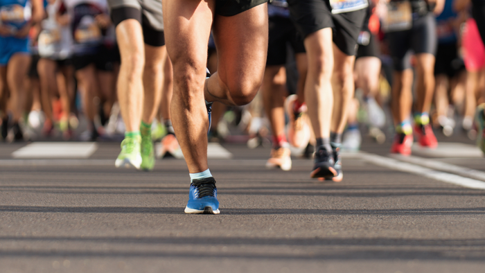 A lower-body shot of a group of runners during a marathon