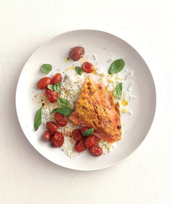 Roasted Curry Salmon With Tomatoes and White Rice on a Plate