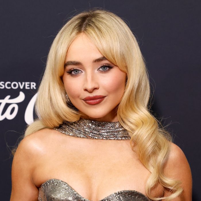 Sabrina Carpenter gracing a red carpet in a stunning metallic gown