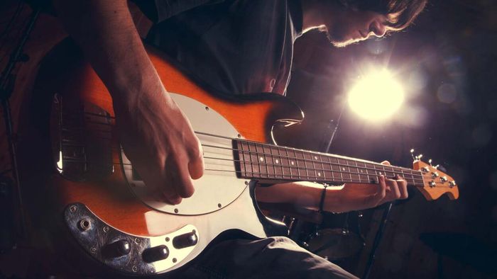 A person strumming a guitar