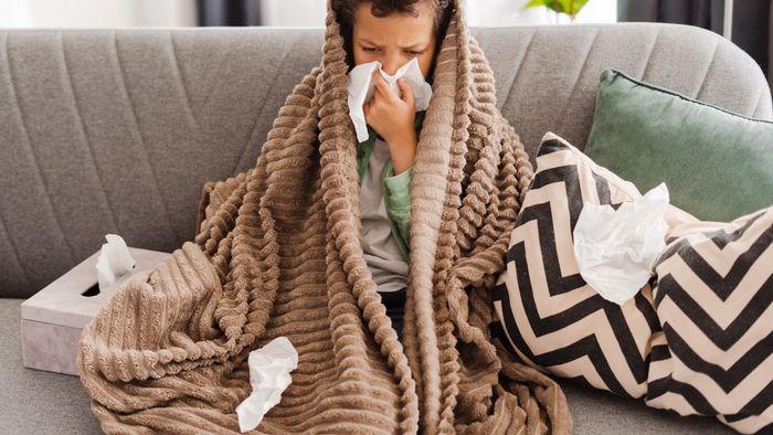 sick child resting on couch