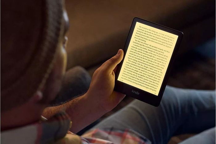 A person enjoys reading on the Amazon Kindle Paperwhite (2022)