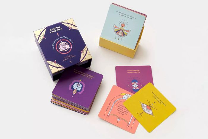 Meditations and Affirmations: 64 Cards to Awaken Your Spirit placed on a white surface.