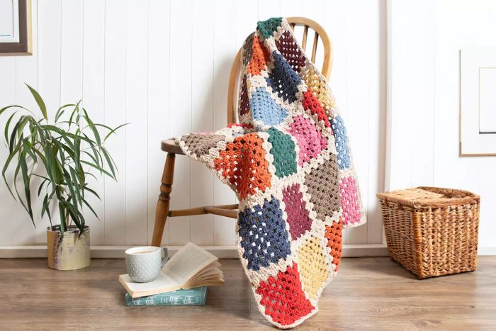 Wool Couture Company Blanket Crochet Kit placed on a chair.