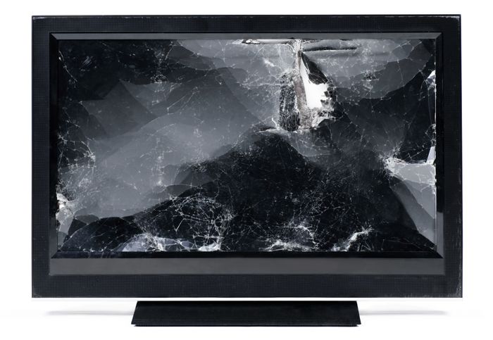 The TV screen was broken, with cracks clearly visible and the glass shattered.