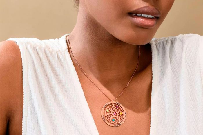 A person wearing the Myka Personalized Family Tree Birthstone Necklace.