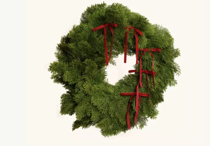 a cedar wreath adorned with red bows