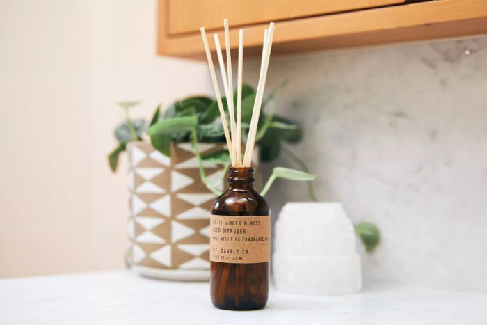 P.F. Candle Co Amber & Moss Reed Diffuser displayed on a countertop.