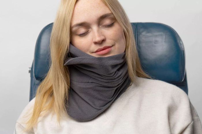 A person using the Trtl Pillow.