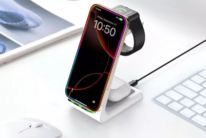 A stylish white JoyGeek 3-in-1 Wireless Charging Station holds a smartphone, smartwatch, and wireless earbuds, with a white mouse placed on a tidy desk