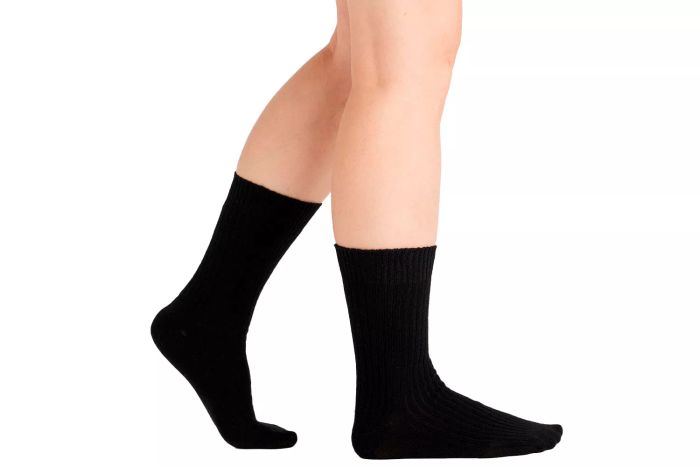 A person wearing Quince Cashmere Trouser Socks.