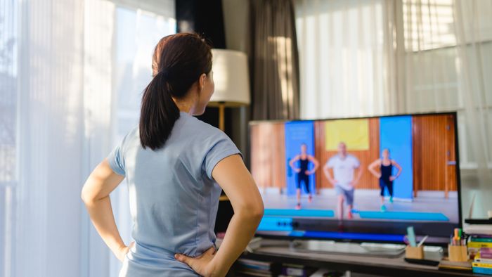 individual working out while watching television