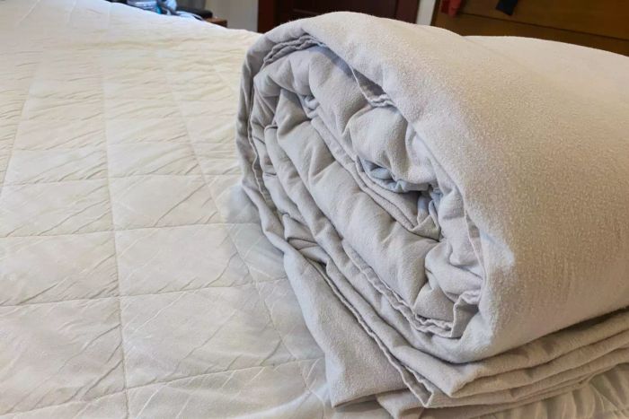 The Lands' End Comfy Super Soft Cotton Flannel Bed Sheet Set neatly folded on a bed