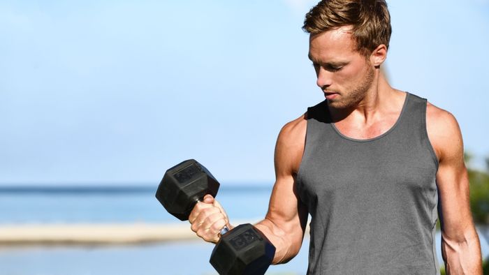 man performing dumbbell exercises