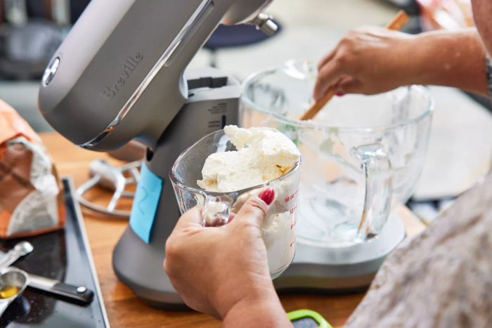 A person testing one of the stand mixers we recommend