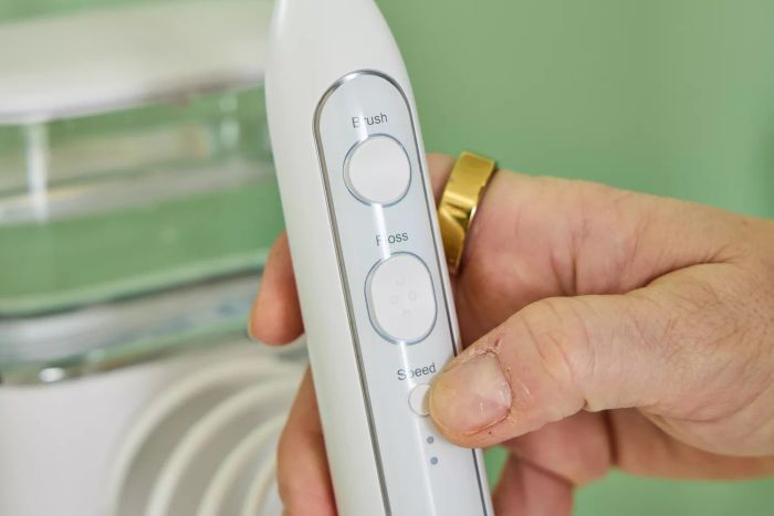 A hand holding the Waterpik Sonic-Fusion 2.0 Professional