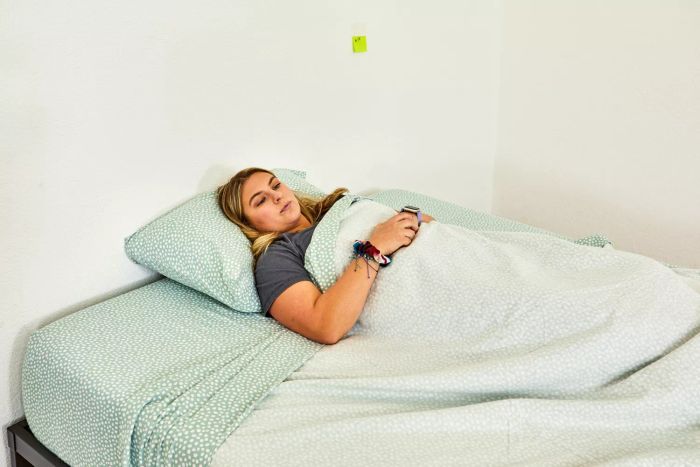 A person sleeping on a bed dressed with the True North by Sleep Philosophy Flannel Sheet Set