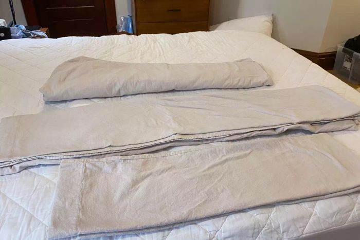 The Lands' End Comfy Super Soft Cotton Flannel Bed Sheet Set folded and placed on a bed